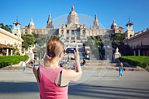 Young woman taking picture of Catalan Art Museum (MNAC) photo