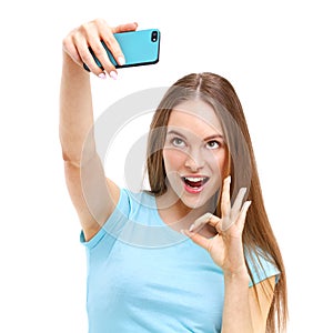 Young woman taking a picture of herself with her camera phone