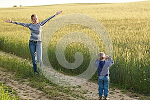 Young woman taking pictures of a child field