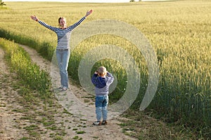 Young woman taking pictures of a child field