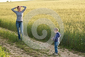 Young woman taking pictures of a child field