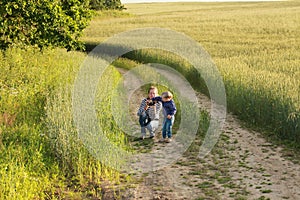 Young woman taking pictures of a child field