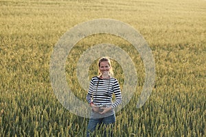 Young woman taking pictures of a child in a field