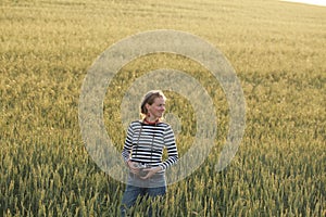 Young woman taking pictures of a child in a field