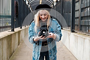 Young woman taking pictures with a film camera