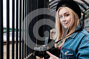 Young woman taking pictures with a film camera