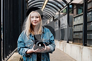 Young woman taking pictures with a film camera