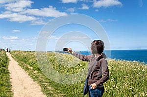 Young Woman Taking Pictures With her Mobile Phone