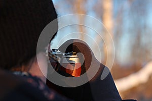 Young woman taking pictures with an old camera