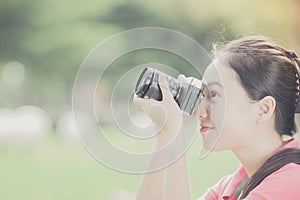 A young woman taking pictures outdoors