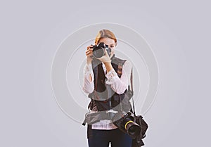 Young woman taking pictures with professional camera