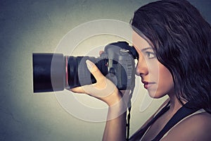 Young woman taking pictures with professional camera