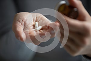 Young woman taking prescribed antibiotic pills or vitamins