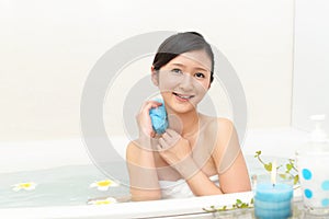 Young woman taking relaxing bath