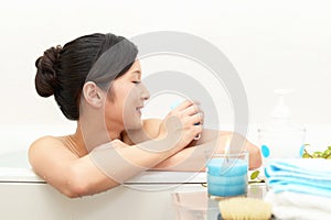 Young woman taking relaxing bath