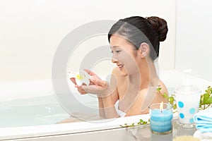 Young woman taking relaxing bath