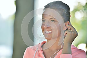 Young woman taking rest after jogging - workout at the park