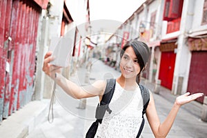 Young Woman taking self image by digital camera in Macao photo