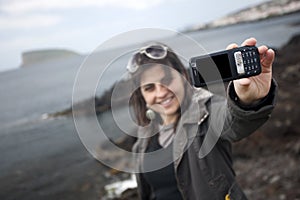 Young woman taking self portrait with mobile phone