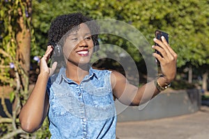Young woman taking selfie with cellphone