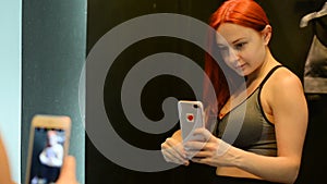 Young woman taking selfie in fitting room