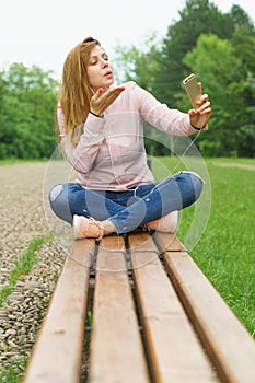 Young woman taking Selfie outdoors