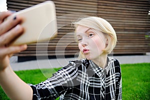 Young woman taking selfie with smart phone