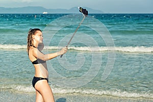 Young woman taking selfie with smartphone