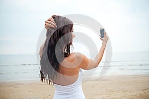 Young woman taking selfie with smartphone