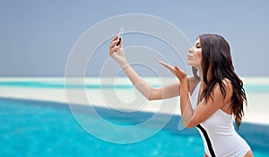 Young woman taking selfie with smartphone
