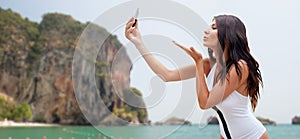 Young woman taking selfie with smartphone