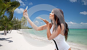 Young woman taking selfie with smartphone