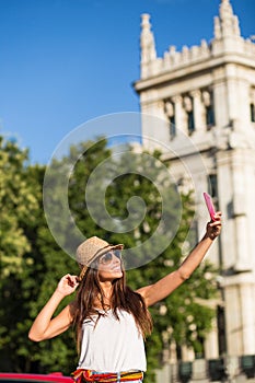 Young woman taking a selfie in the street