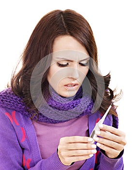 Young woman taking thermometer.