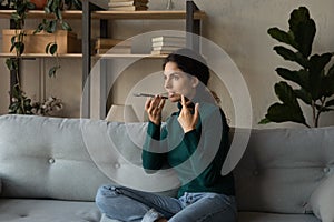 Young woman talk on loudspeaker on smartphone