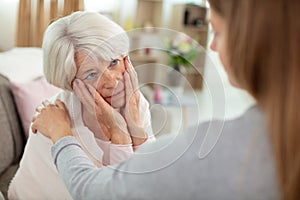 young woman talk with worried elderly mom