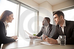 Young woman talking with employers on interview
