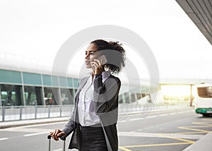 Young woman talking on mobile phone at airport
