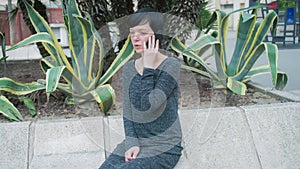 Young woman talking on the mobile phone outdoor.