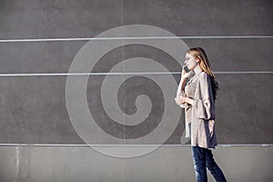 Young woman talking phone on street