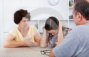 Young woman talking to mature parents