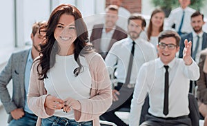 young woman talking to a speaker during a business seminar.