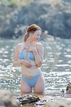 Young woman tanning on the beach