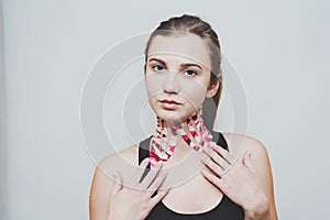 Young woman with tape for facelift with kinesio. Esthetic taping. Salon procedures