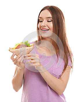 Young woman with tasty sandwich on background