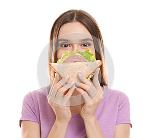 Young woman with tasty sandwich on background