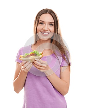 Young woman with tasty sandwich on white