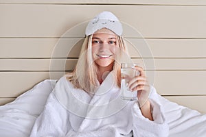 Young woman teenager with a glass of clean water