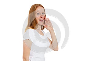 Young woman telling something, red head girl telling a secret. Portrait young happy woman who is calling to someone. Funny girl