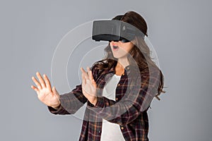 Young woman testing virtual reality helmet